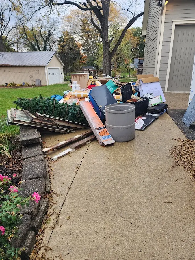 Dumpster being loaded with debris for 12 Yard Dumpster Rental in Sunnyside